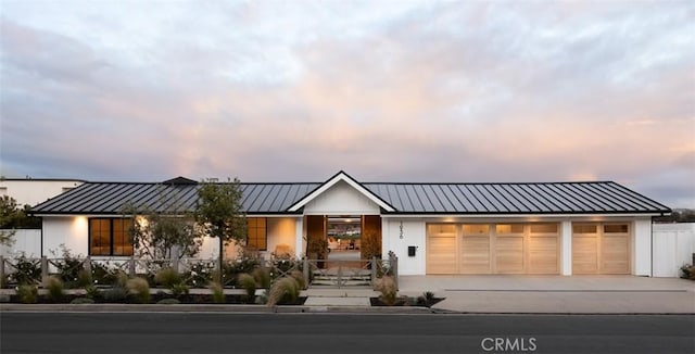 1936 Galaxy Dr, Newport Beach, CA 92660 - modern farmhouse with concrete driveway, an attached garage, a standing seam roof, metal roof, and covered porch