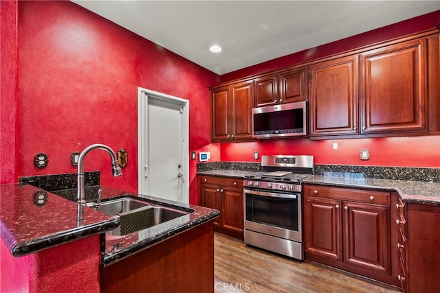19539 Laroda, Saugus, CA 91350 - kitchen with stainless steel appliances, a sink, wood finished floors, dark stone counters, and recessed lighting