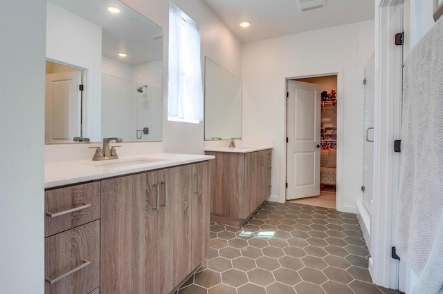 35140 Bergamot, Fallbrook, CA 92028 - bathroom with a shower stall, a walk in closet, two vanities, recessed lighting, and tile patterned flooring