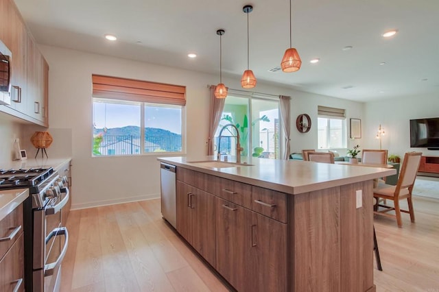 35140 Bergamot, Fallbrook, CA 92028 - kitchen featuring appliances with stainless steel finishes, modern cabinets, an island with sink, light wood finished floors, and recessed lighting