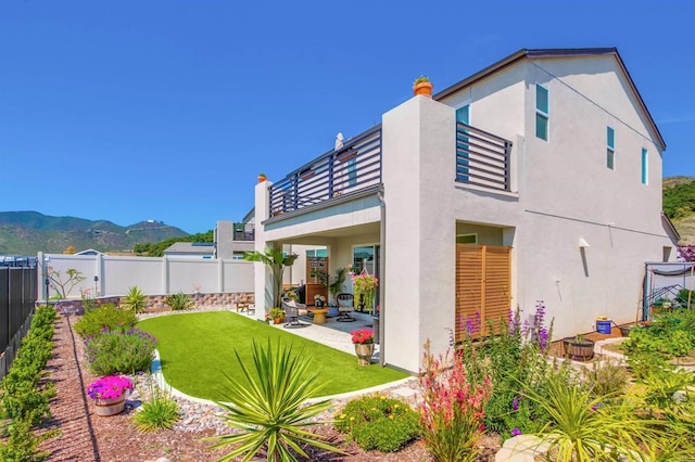 35140 Bergamot, Fallbrook, CA 92028 - back of house featuring a balcony, a fenced backyard, a patio area, and stucco siding