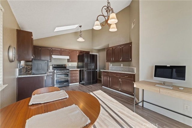 2433 N Knoll Ave, Fresno, CA 93722 - kitchen featuring double oven range, freestanding refrigerator, high vaulted ceiling, light countertops, and dark wood-style flooring