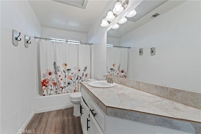 2433 N Knoll Ave, Fresno, CA 93722 - bathroom with vanity, wood finished floors, toilet, and shower / bath combination with curtain