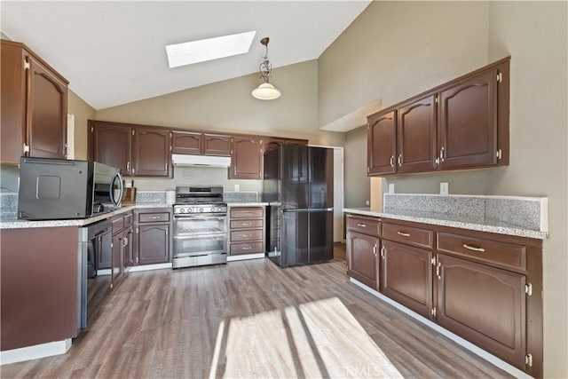 2433 N Knoll Ave, Fresno, CA 93722 - kitchen with range with two ovens, freestanding refrigerator, a skylight, under cabinet range hood, and light wood-style floors