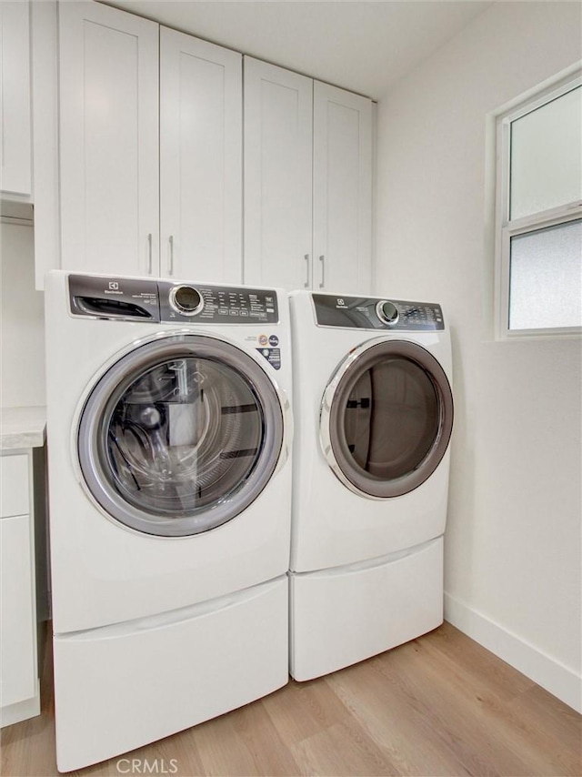 436 Cheyenne Pl, Placentia, CA 92870 - washroom featuring washing machine and dryer, cabinet space, light wood-type flooring, and baseboards