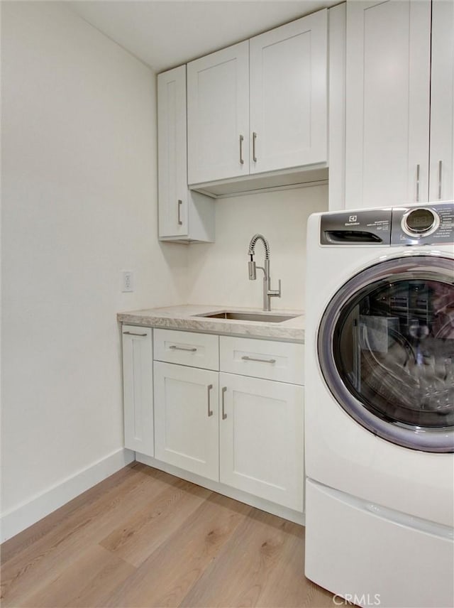 436 Cheyenne Pl, Placentia, CA 92870 - laundry area featuring washer / clothes dryer, cabinet space, light wood-type flooring, and baseboards