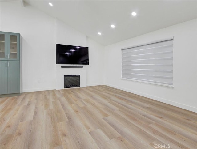 436 Cheyenne Pl, Placentia, CA 92870 - unfurnished living room featuring a glass covered fireplace, recessed lighting, light wood finished floors, baseboards, and high vaulted ceiling