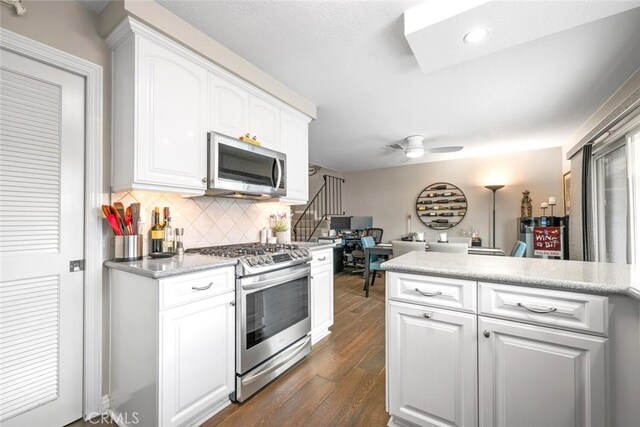 6898 Breton Way, Cypress, CA 90630 - kitchen with appliances with stainless steel finishes, dark wood-style flooring, decorative backsplash, white cabinets, and light countertops