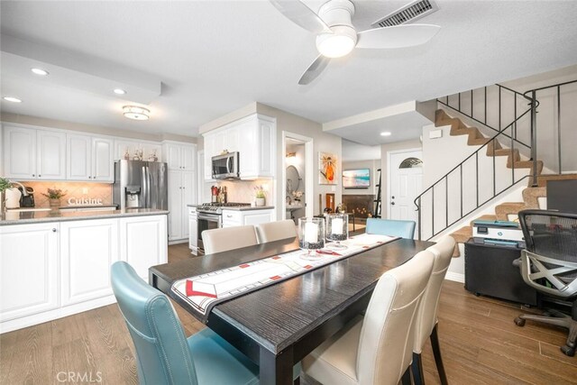 6898 Breton Way, Cypress, CA 90630 - dining room with recessed lighting, wood finished floors, ceiling fan, and stairway