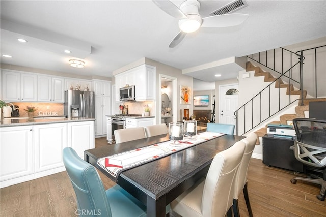 6898 Breton Way, Cypress, CA 90630 - dining room featuring recessed lighting, wood finished floors, ceiling fan, and stairs
