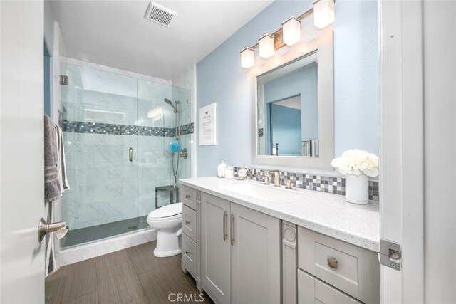 6898 Breton Way, Cypress, CA 90630 - full bathroom with toilet, vanity, a shower stall, backsplash, and tile patterned flooring