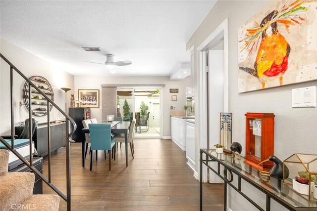 6898 Breton Way, Cypress, CA 90630 - dining area with ceiling fan, dark wood-type flooring, and stairway