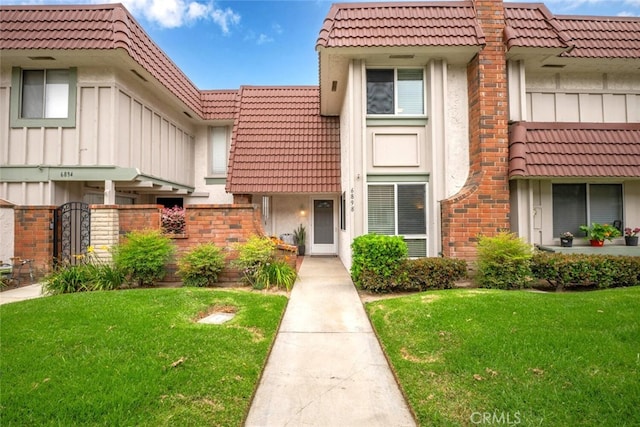 6898 Breton Way, Cypress, CA 90630 - view of front facade featuring a tiled roof, stucco siding, and a front lawn