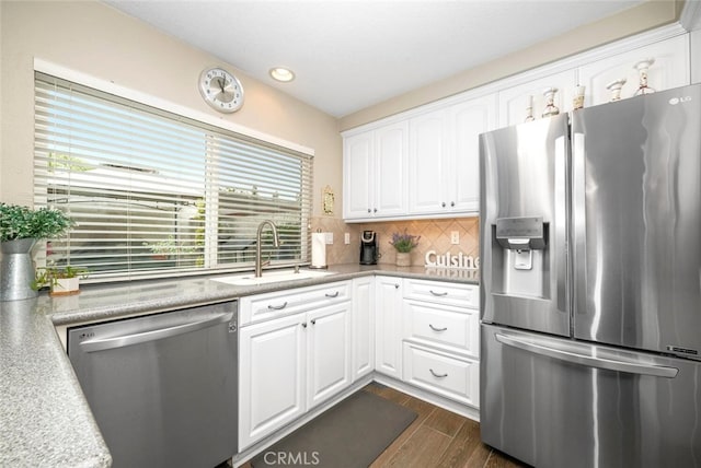 6898 Breton Way, Cypress, CA 90630 - kitchen with appliances with stainless steel finishes, dark wood-style flooring, white cabinets, backsplash, and light countertops