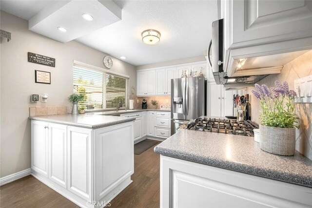 6898 Breton Way, Cypress, CA 90630 - kitchen featuring stainless steel appliances, a peninsula, white cabinets, dark wood-style floors, and recessed lighting