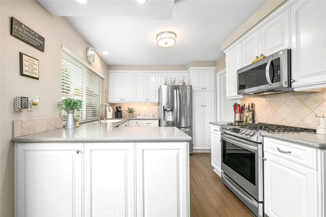 6898 Breton Way, Cypress, CA 90630 - kitchen with appliances with stainless steel finishes, a sink, a peninsula, and white cabinetry