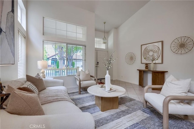 30 Oakhurst Rd, Irvine, CA 92620 - living area featuring a towering ceiling, tile patterned flooring, and baseboards