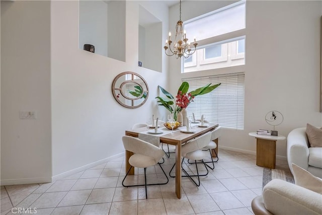 30 Oakhurst Rd, Irvine, CA 92620 - dining room featuring a chandelier, baseboards, a towering ceiling, and light tile patterned floors
