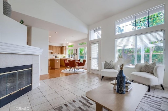 30 Oakhurst Rd, Irvine, CA 92620 - living area with light tile patterned floors, high vaulted ceiling, a tiled fireplace, and recessed lighting