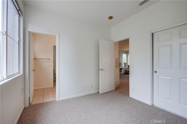 30 Oakhurst Rd, Irvine, CA 92620 - unfurnished bedroom featuring carpet floors, multiple windows, baseboards, and connected bathroom