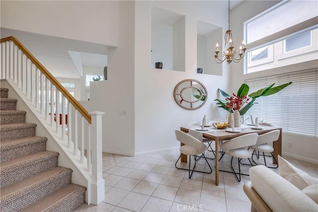 30 Oakhurst Rd, Irvine, CA 92620 - dining area featuring stairs, a chandelier, light tile patterned flooring, baseboards, and a high ceiling