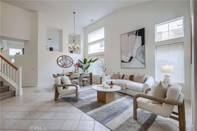 30 Oakhurst Rd, Irvine, CA 92620 - living area with a towering ceiling, a chandelier, stairway, light tile patterned floors, and baseboards