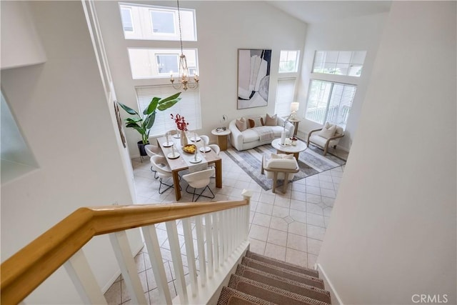 30 Oakhurst Rd, Irvine, CA 92620 - living area featuring a chandelier, plenty of natural light, high vaulted ceiling, stairs, and baseboards