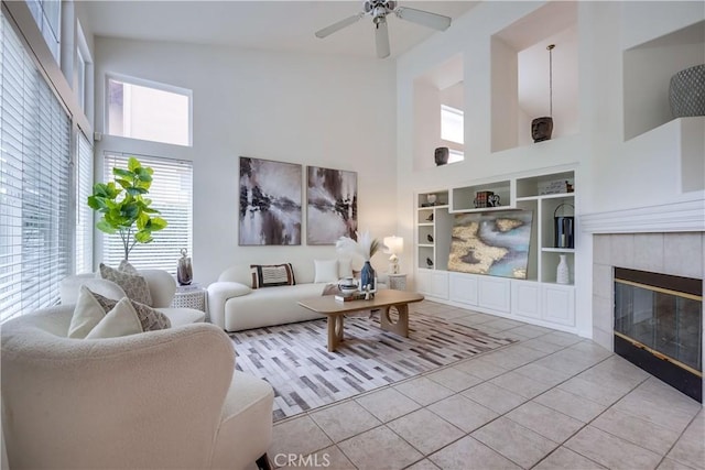 30 Oakhurst Rd, Irvine, CA 92620 - living room featuring a towering ceiling, built in features, tile patterned flooring, a tile fireplace, and a ceiling fan