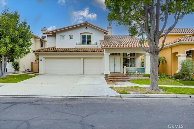 30 Oakhurst Rd, Irvine, CA 92620 - mediterranean / spanish house featuring a tiled roof, an attached garage, a balcony, and covered porch