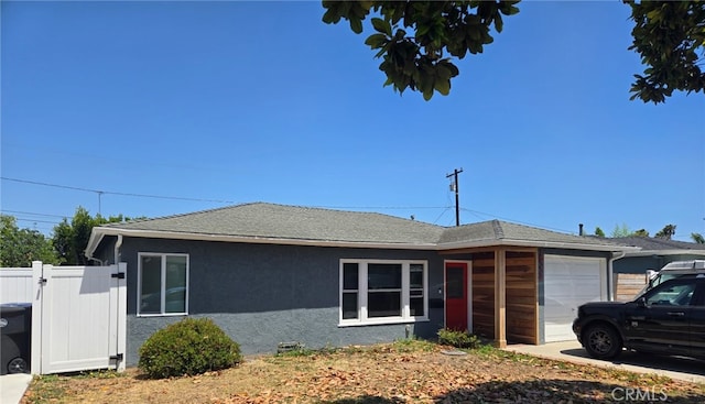 18334 Glenburn Ave, Torrance, CA 90504 - view of front of home with an attached garage, stucco siding, a shingled roof, and a gate