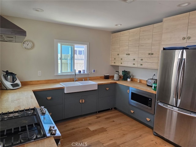 18334 Glenburn Ave, Torrance, CA 90504 - kitchen with appliances with stainless steel finishes, range hood, butcher block countertops, light wood-type flooring, and recessed lighting