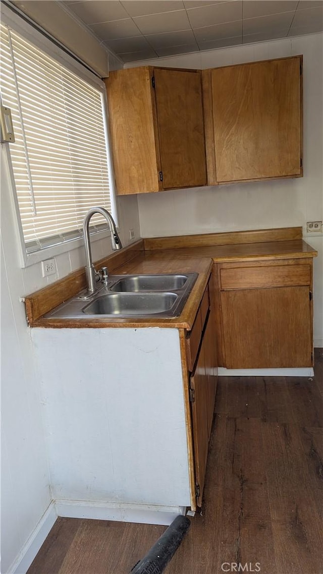 6445 Pony Rd, Johnson Valley, CA 92285 - kitchen with dark wood-style flooring, a sink, and brown cabinetry