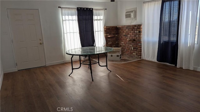 6445 Pony Rd, Johnson Valley, CA 92285 - dining space with an AC wall unit, wood finished floors, and baseboards