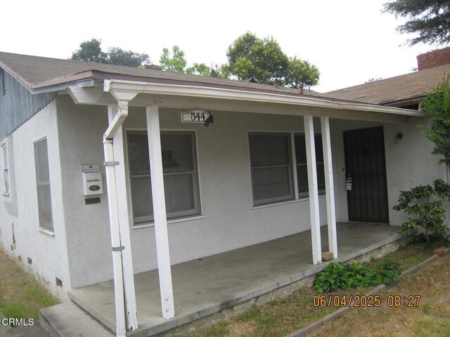 542 1st St, Fillmore, CA 93015 - doorway to property featuring stucco siding, a patio area, and a shingled roof