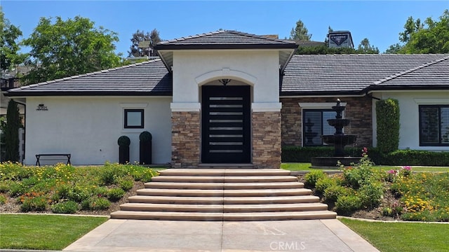30195 Corte Coelho, Temecula, CA 92591 - view of front of home featuring stucco siding, stone siding, and a tile roof