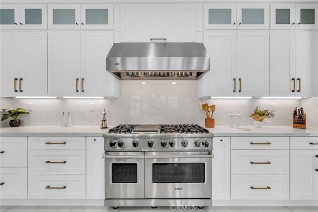 30195 Corte Coelho, Temecula, CA 92591 - kitchen featuring double oven range, wall chimney range hood, light countertops, and white cabinetry