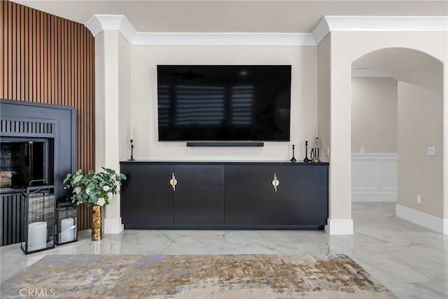 30195 Corte Coelho, Temecula, CA 92591 - unfurnished living room with marble tiled flooring, arched walkways, a decorative wall, wainscoting, and crown molding