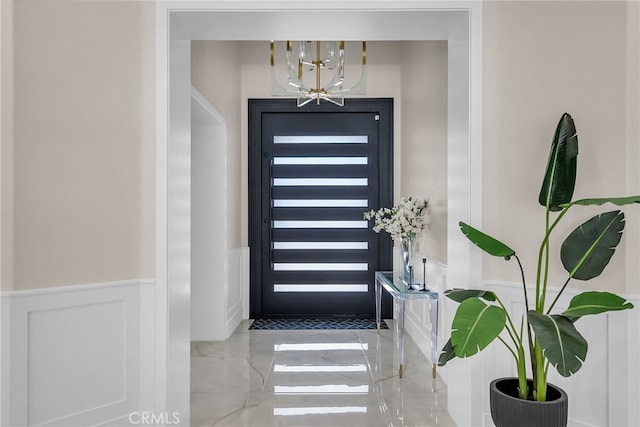30195 Corte Coelho, Temecula, CA 92591 - foyer with a wainscoted wall, a chandelier, a decorative wall, and marble tiled flooring
