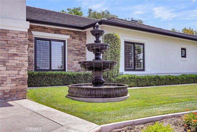 30195 Corte Coelho, Temecula, CA 92591 - view of front facade with stone siding, a front lawn, a tile roof, and stucco siding