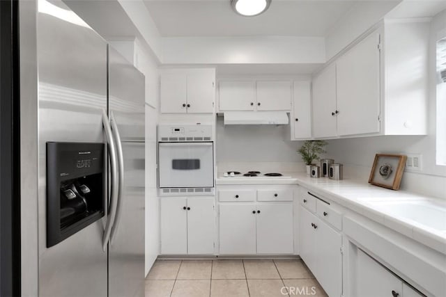972 E California Blvd Unit 309, Pasadena, CA 91106 - kitchen featuring white appliances, white cabinets, under cabinet range hood, light countertops, and light tile patterned floors