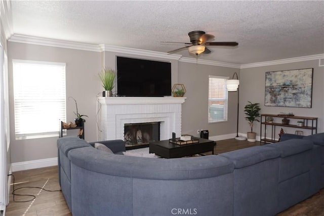 2622 Presidio Ln, Corona, CA 92879 - living area with crown molding, ceiling fan, a textured ceiling, a brick fireplace, and wood finished floors