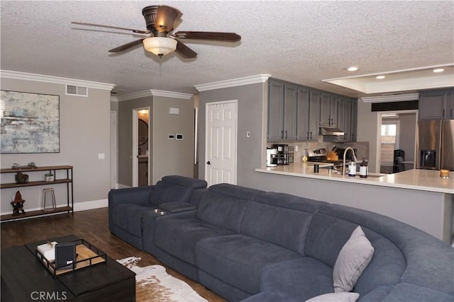 2622 Presidio Ln, Corona, CA 92879 - living room with a textured ceiling, ceiling fan, dark wood finished floors, crown molding, and a tray ceiling