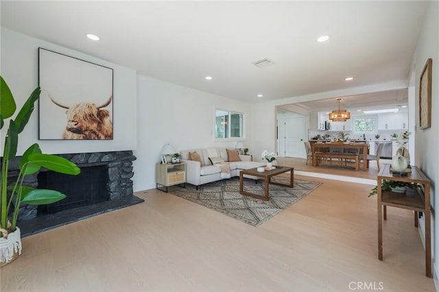 1304 Walling Ave, Brea, CA 92821 - living room featuring wood finished floors, a fireplace, recessed lighting, and a chandelier