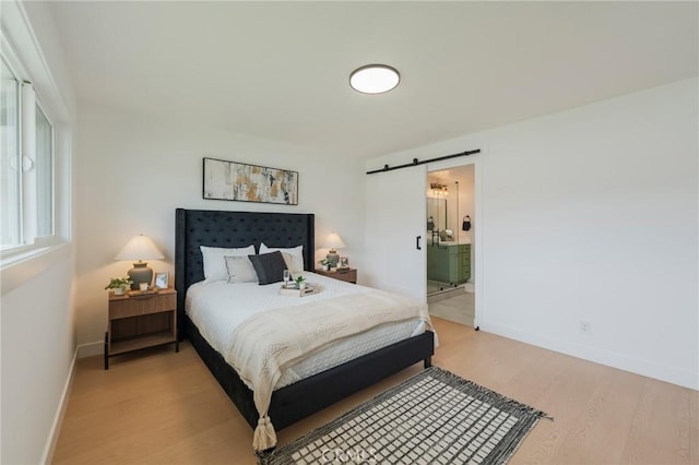 1304 Walling Ave, Brea, CA 92821 - bedroom with a barn door, light wood-type flooring, baseboards, and ensuite bath