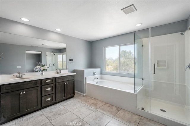 30574 Saddlehorn Way, Menifee, CA 92584 - bathroom featuring a garden tub, double vanity, a stall shower, recessed lighting, and tile patterned floors