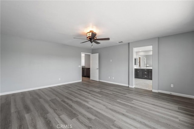 30574 Saddlehorn Way, Menifee, CA 92584 - unfurnished living room featuring ceiling fan, wood finished floors, and baseboards
