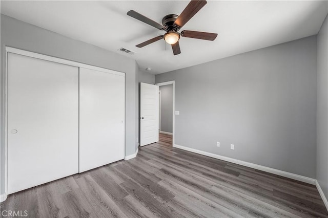 30574 Saddlehorn Way, Menifee, CA 92584 - unfurnished bedroom featuring wood finished floors, baseboards, and a closet