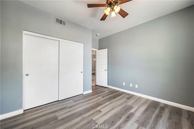 30574 Saddlehorn Way, Menifee, CA 92584 - unfurnished bedroom featuring wood finished floors, a closet, and a ceiling fan