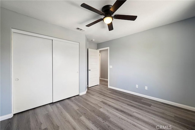 30574 Saddlehorn Way, Menifee, CA 92584 - unfurnished bedroom featuring wood finished floors, a closet, and ceiling fan