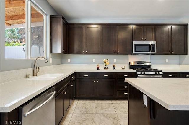 30574 Saddlehorn Way, Menifee, CA 92584 - kitchen with stainless steel appliances, dark brown cabinets, and light tile patterned floors